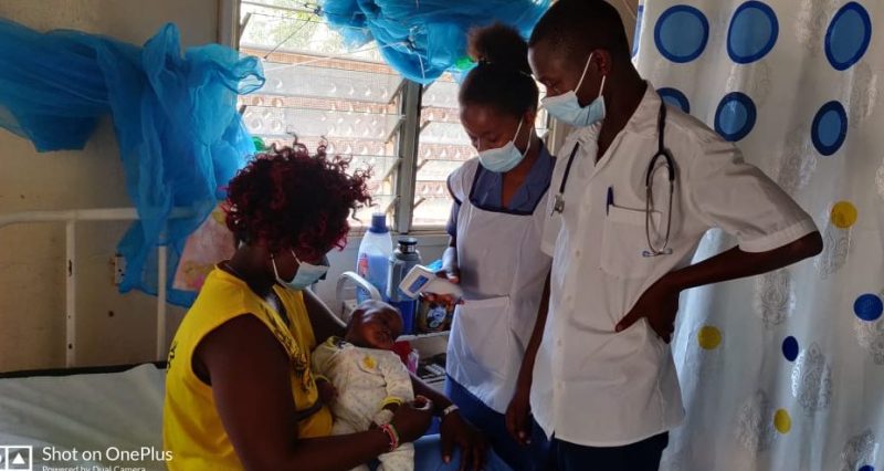 KMH staff checking vitals of a new born with mother